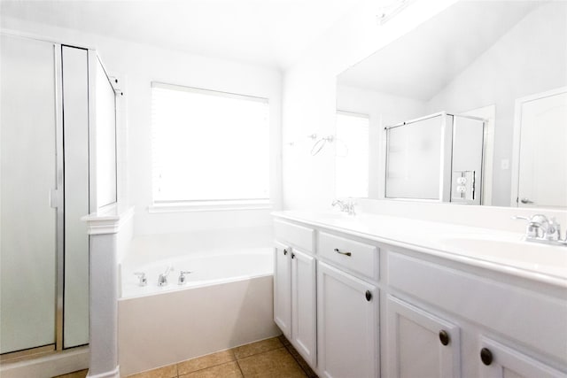 bathroom featuring shower with separate bathtub, vaulted ceiling, tile patterned floors, and vanity