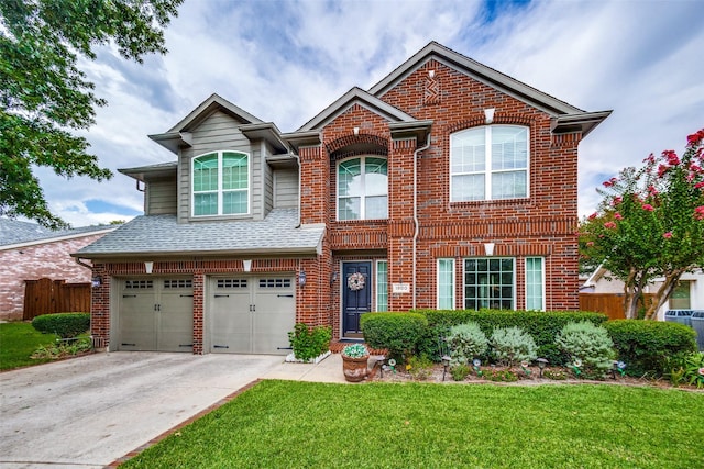 view of front of house featuring a front lawn and a garage