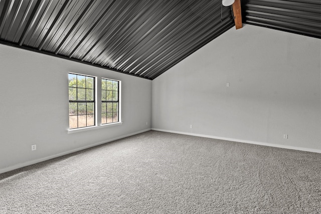 additional living space featuring lofted ceiling with beams, carpet, and baseboards