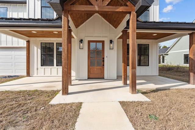 view of exterior entry with board and batten siding