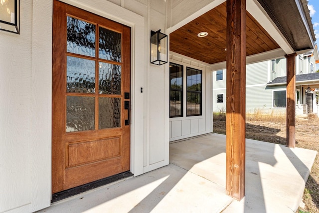 entrance to property featuring covered porch and board and batten siding