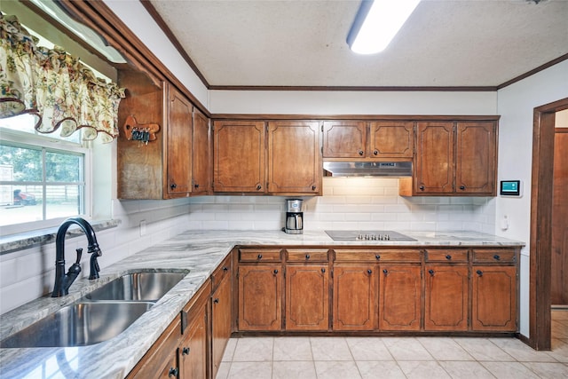 kitchen featuring black electric cooktop, crown molding, decorative backsplash, and sink