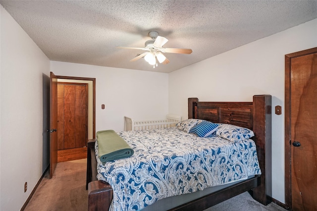 carpeted bedroom with a textured ceiling and ceiling fan