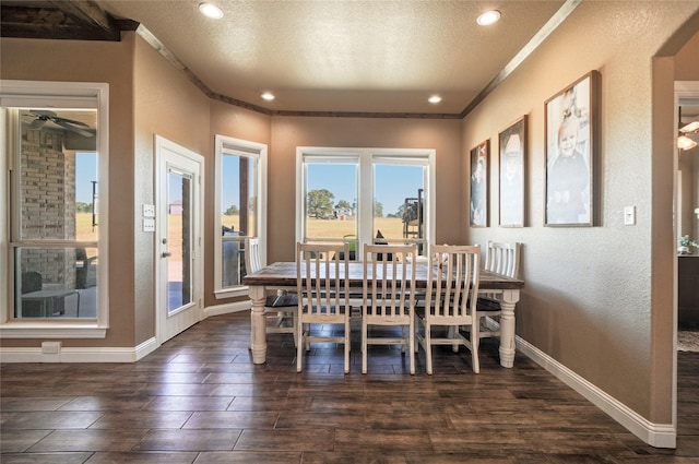 dining space featuring a textured ceiling and crown molding