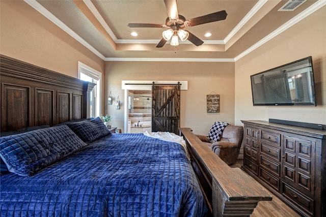 bedroom with ceiling fan, crown molding, a raised ceiling, and a barn door