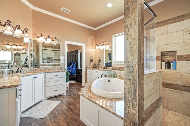 bathroom with shower with separate bathtub, hardwood / wood-style floors, ornamental molding, vanity, and plenty of natural light