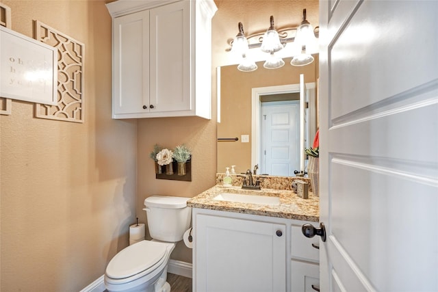 bathroom featuring toilet and vanity