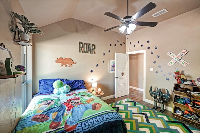 bedroom with ceiling fan, vaulted ceiling, and dark hardwood / wood-style floors