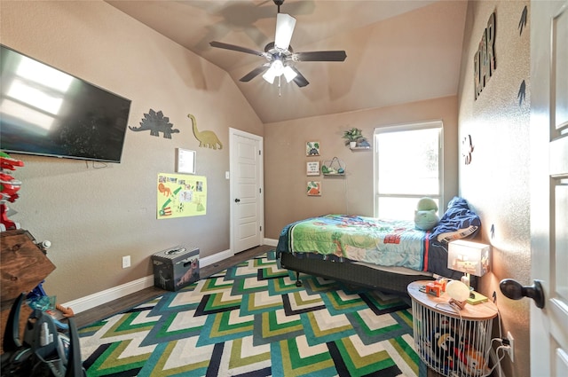 bedroom with hardwood / wood-style flooring, ceiling fan, and vaulted ceiling