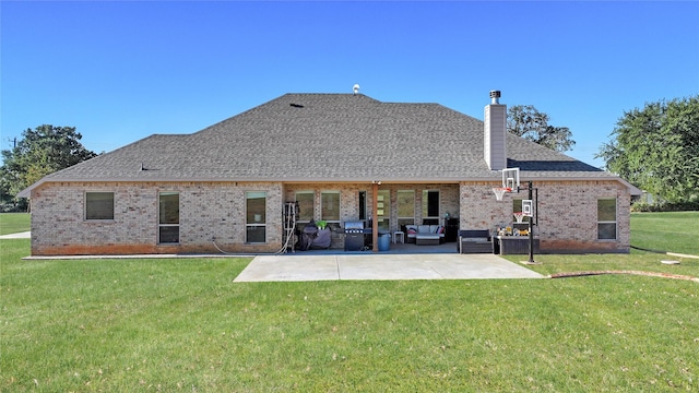 back of house with a yard, an outdoor living space, and a patio