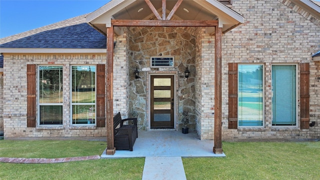 entrance to property featuring a yard