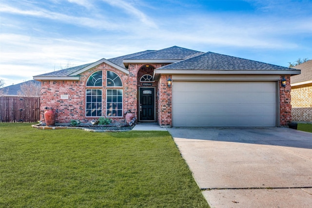 ranch-style house with a front yard and a garage