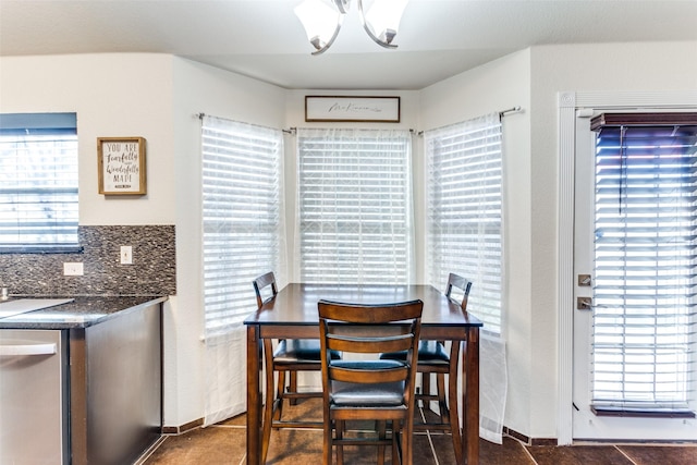 tiled dining room with an inviting chandelier