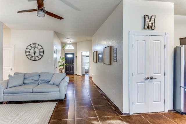 tiled living room featuring ceiling fan