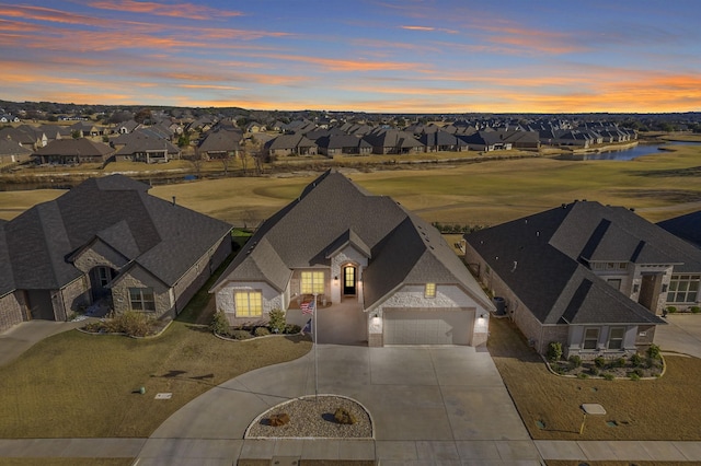 view of front of house featuring a yard and a garage