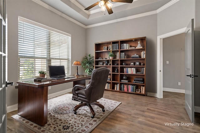 home office with hardwood / wood-style floors, ornamental molding, a raised ceiling, and ceiling fan