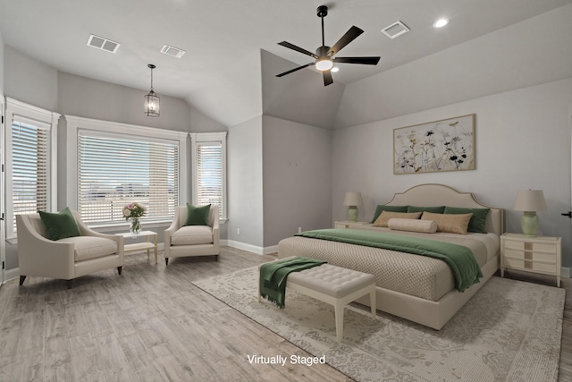 bedroom with multiple windows, lofted ceiling, hardwood / wood-style flooring, and ceiling fan