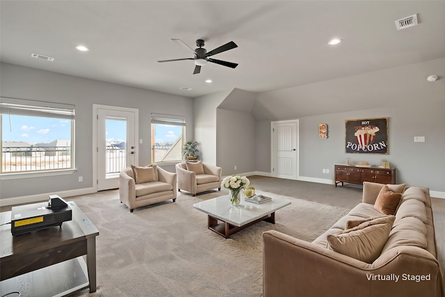 carpeted living room featuring ceiling fan