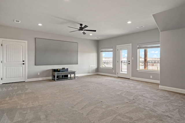 unfurnished living room with ceiling fan and light carpet