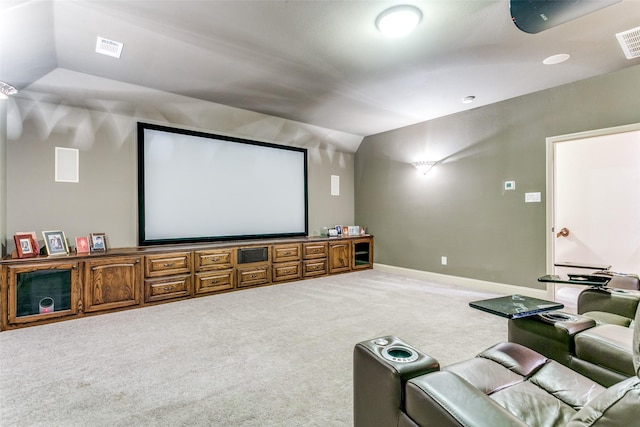 cinema room featuring lofted ceiling and carpet flooring