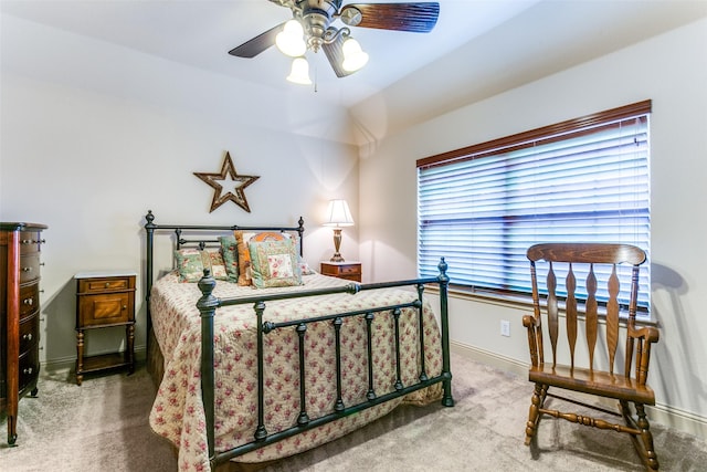 carpeted bedroom with ceiling fan and vaulted ceiling