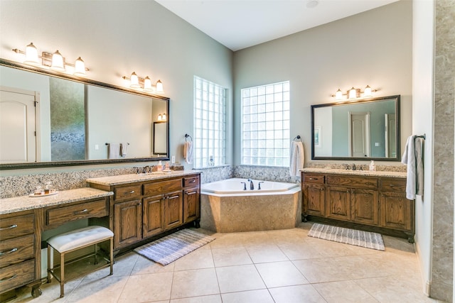 bathroom with vanity, tiled tub, and tile patterned floors