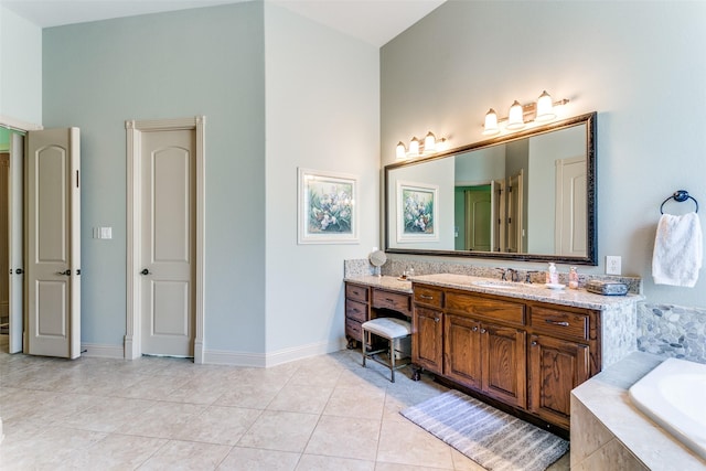 bathroom featuring vanity, tile patterned flooring, and a relaxing tiled tub