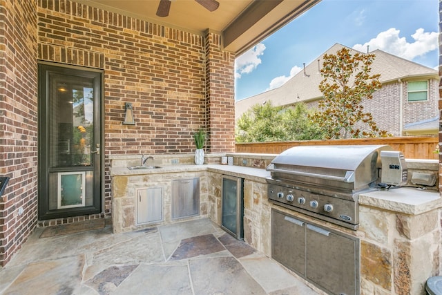 view of patio / terrace with exterior kitchen, grilling area, ceiling fan, and sink