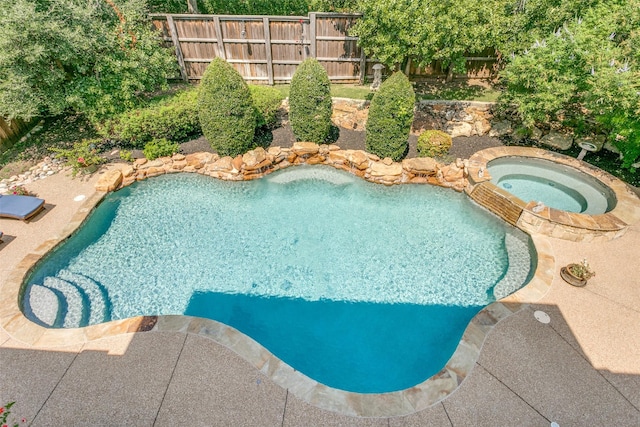 view of swimming pool with an in ground hot tub