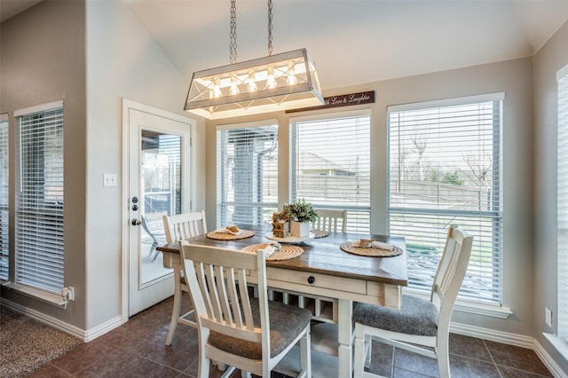 tiled dining area featuring lofted ceiling