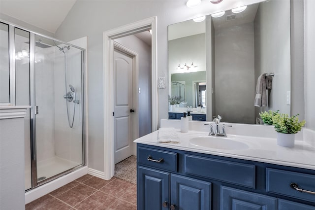 bathroom with lofted ceiling, an enclosed shower, vanity, and tile patterned floors