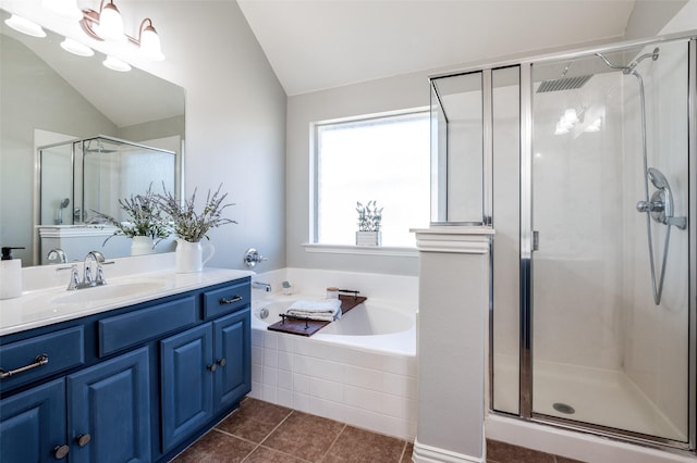 bathroom with tile patterned flooring, plus walk in shower, vaulted ceiling, and vanity