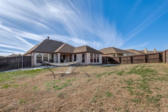 rear view of house with a lawn