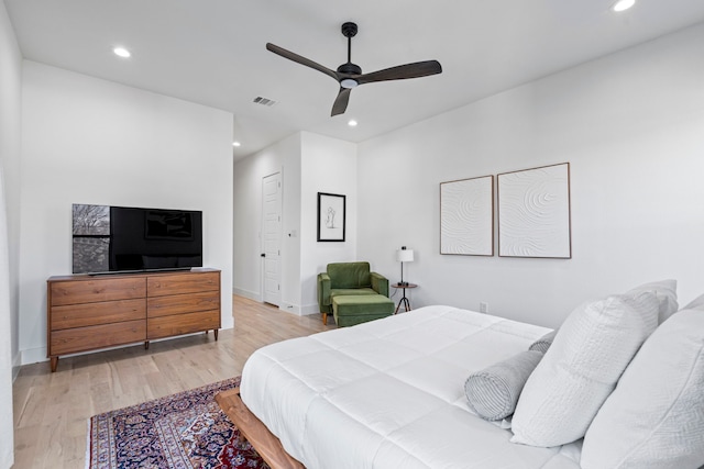 bedroom with a closet, ceiling fan, and light hardwood / wood-style flooring