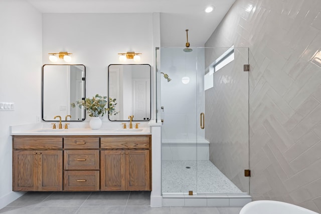 bathroom featuring tile patterned flooring, walk in shower, and vanity