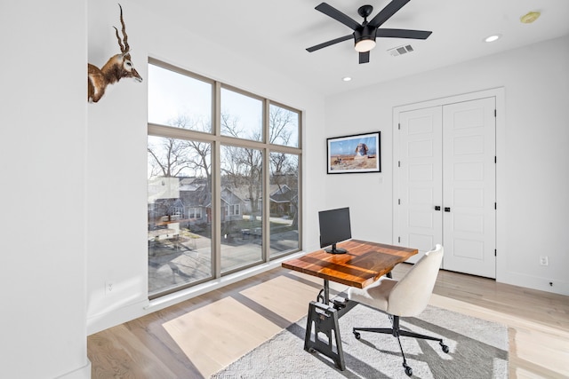 office area with ceiling fan and light hardwood / wood-style floors