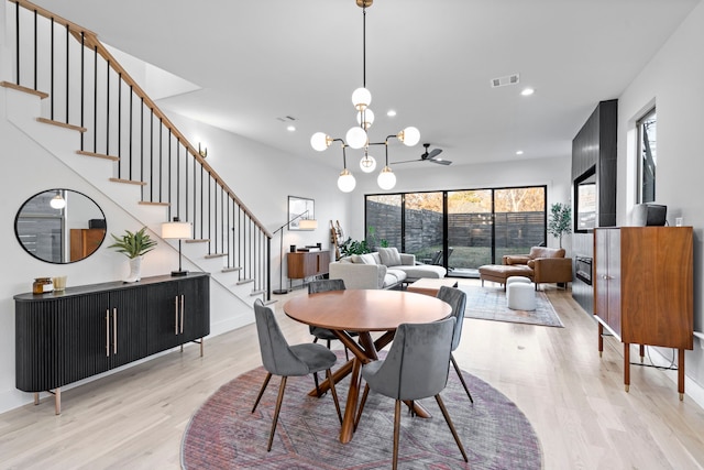 dining room with light hardwood / wood-style flooring and a chandelier