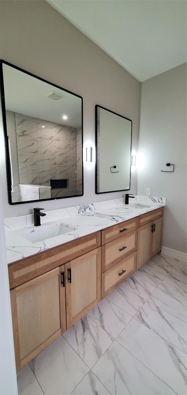 bathroom featuring a shower and vanity