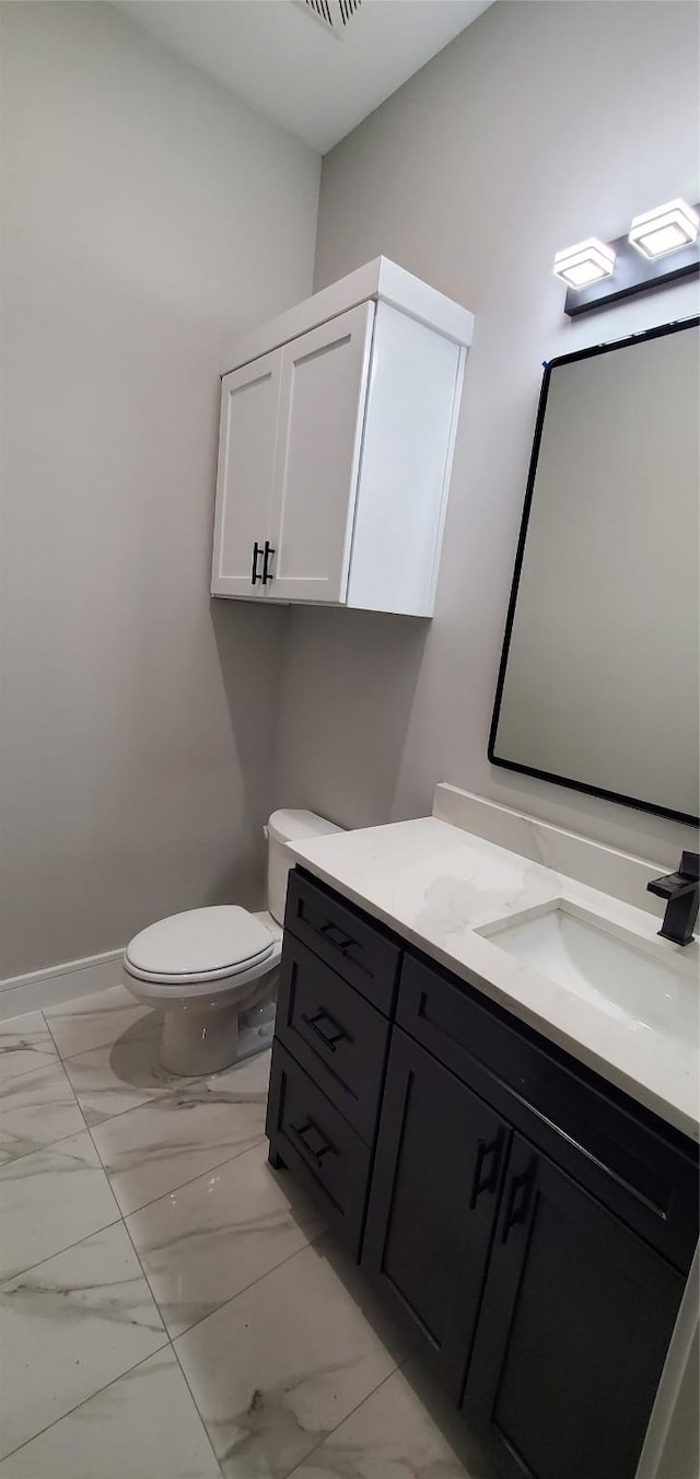 bathroom with toilet and vanity