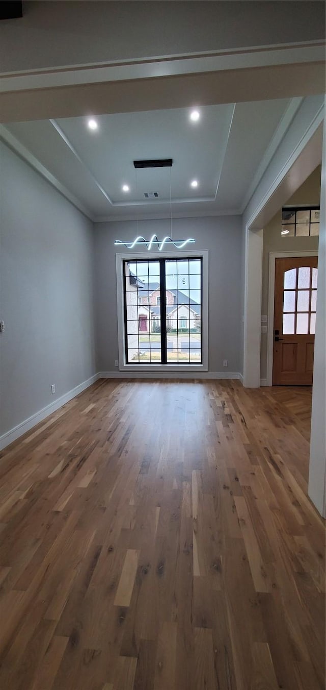 unfurnished dining area featuring crown molding and dark hardwood / wood-style floors