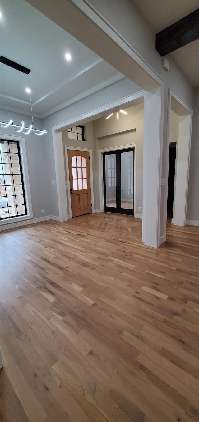 foyer featuring french doors, hardwood / wood-style floors, and plenty of natural light