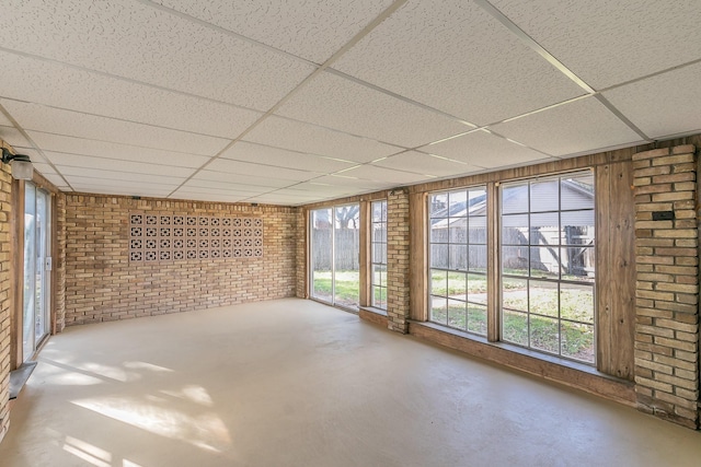 unfurnished sunroom with a drop ceiling