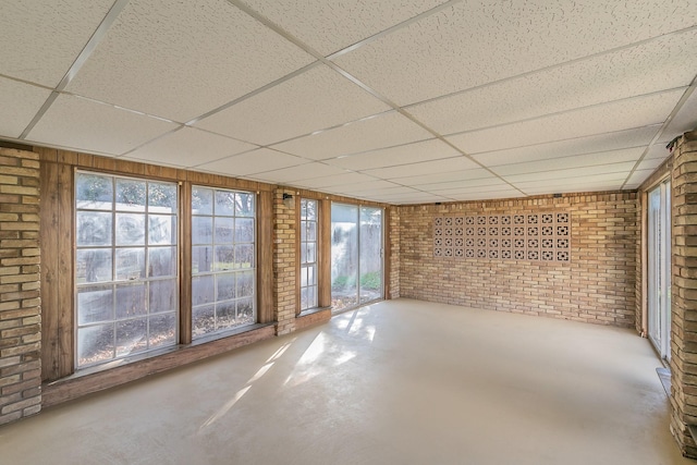 unfurnished sunroom featuring a paneled ceiling