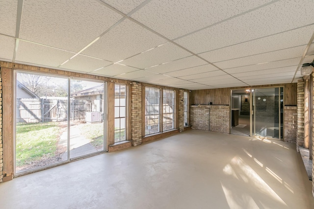 unfurnished sunroom with a drop ceiling