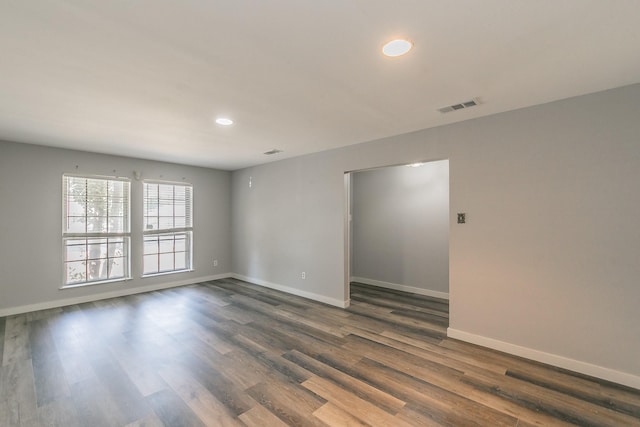 unfurnished room featuring dark wood-type flooring