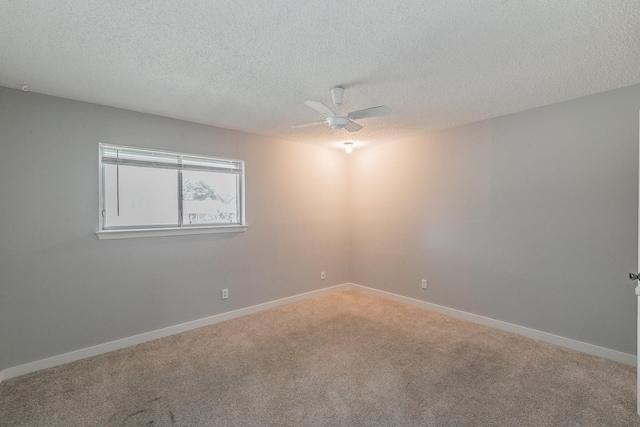 unfurnished room with a textured ceiling, ceiling fan, and carpet