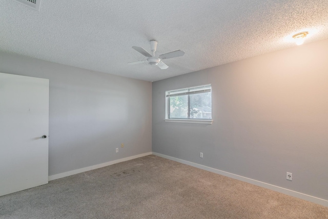 carpeted spare room featuring a textured ceiling and ceiling fan