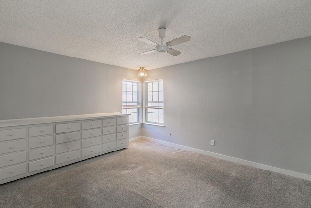 carpeted empty room with a textured ceiling and ceiling fan