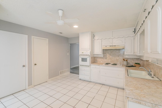 2005 Winewood Ln, Arlington, TX 76013 - unfurnished living room with wood finished floors, baseboards, a brick fireplace, a ceiling fan, and a textured ceiling