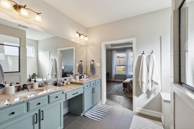 bathroom featuring a healthy amount of sunlight and vanity